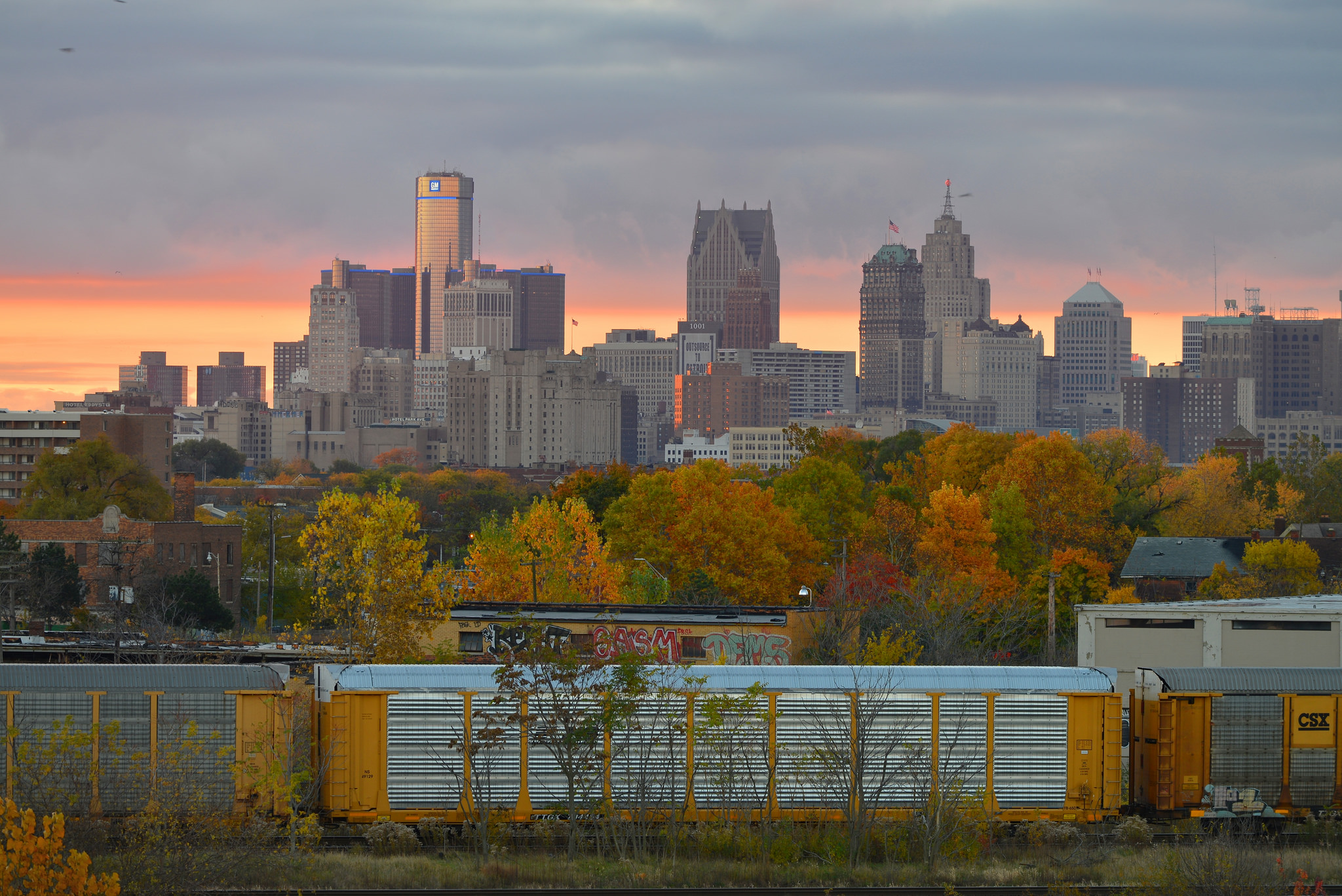 Fall foliage is seen against a backdrop of Detroit's skyline.