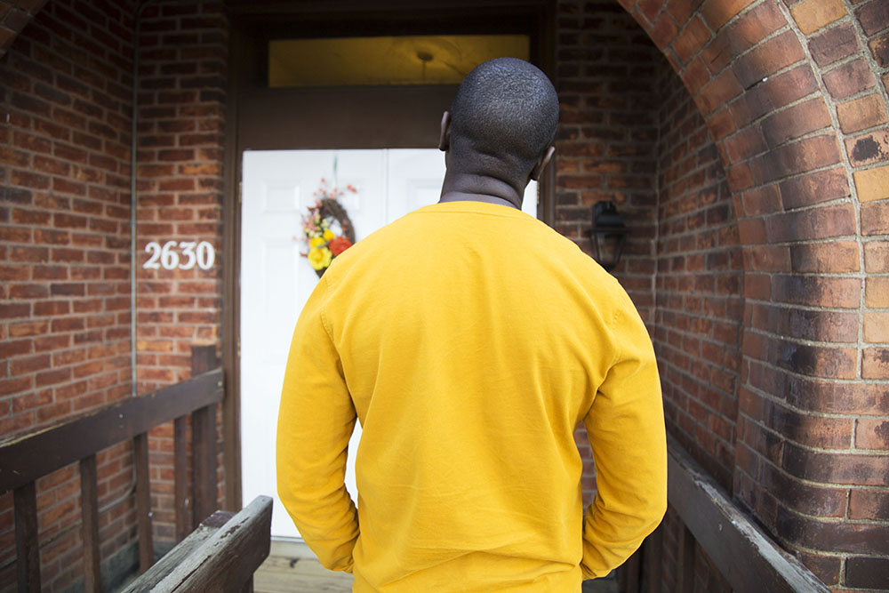 A man stands with his back turned to the camera.
