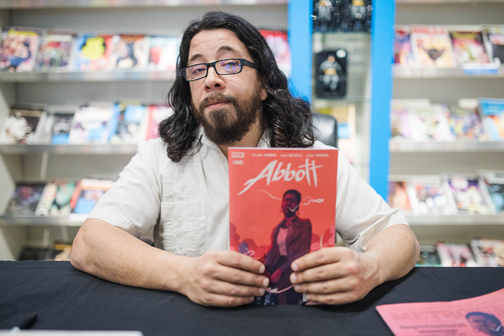 Saladin Ahmed holds his comic, Abbott.